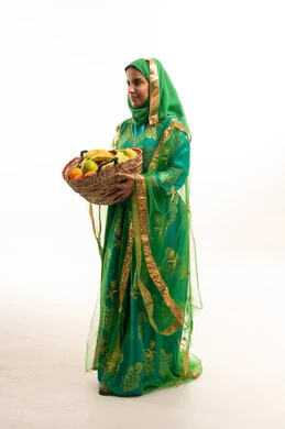 Saudi Woman in Traditional Green Dress with Fruit Basket