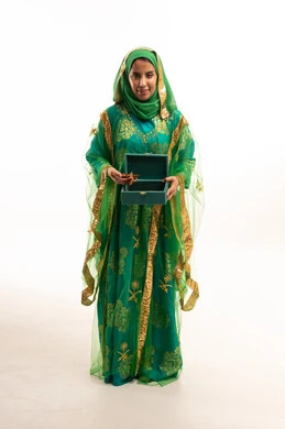 Saudi Woman in Traditional Green Dress with Gift Box