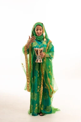 Saudi Woman in Green Traditional Dress with Incense