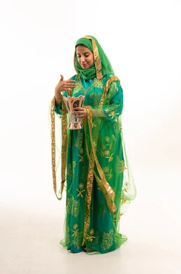 Saudi Woman in Traditional Green Dress Holding Incense Burner