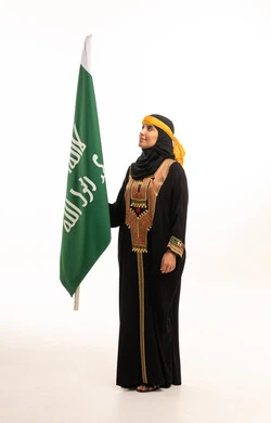 Saudi Woman with National Flag in Traditional Dress - Photo