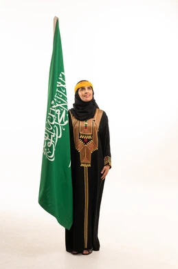 Saudi Woman with National Flag in Traditional Dress