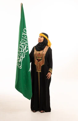 Saudi Woman with National Flag in Traditional Dress