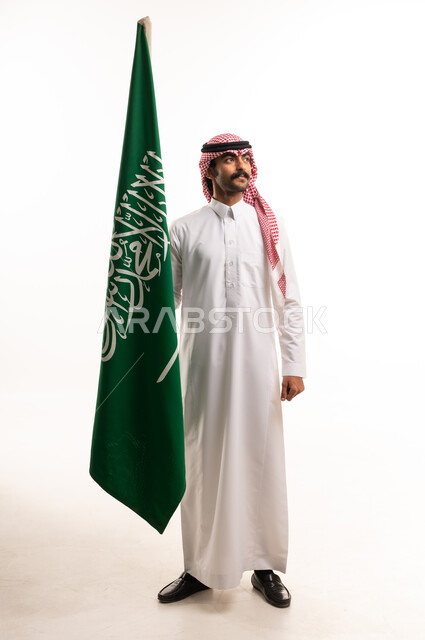Saudi Man in Traditional Dress Holding National Flag