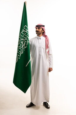 Saudi Man Holding National Flag on White Background