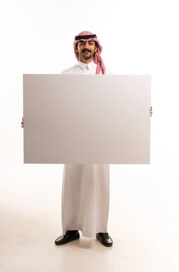 Saudi Man in Traditional Dress Holding Blank White Board