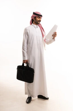 Saudi Businessman in Thobe Reading Document with Briefcase