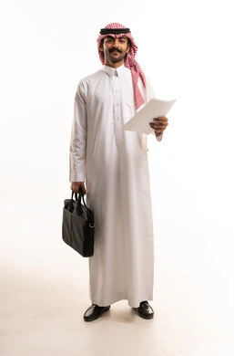 Saudi Businessman in Traditional Thobe Holding Documents