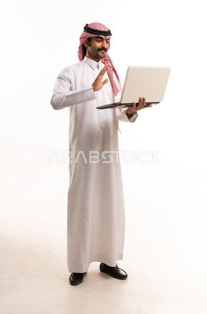 Saudi Man Using Laptop for Video Call in Studio