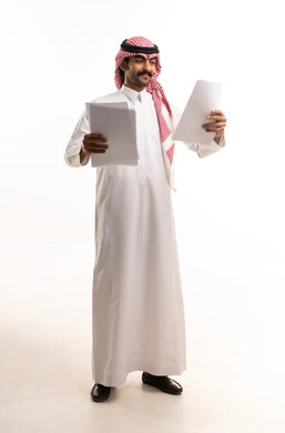 Saudi Man in Traditional Dress Reading Documents Studio