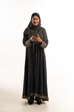 Saudi Woman in Black Abaya Using Smartphone in Studio