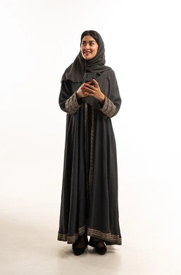 Saudi Woman in Traditional Black Abaya Holding Smartphone
