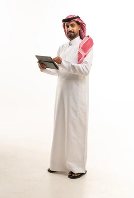 Saudi Man in Traditional Thobe Using Digital Tablet