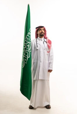 Saudi Doctor in Lab Coat Holding Saudi Arabia Flag