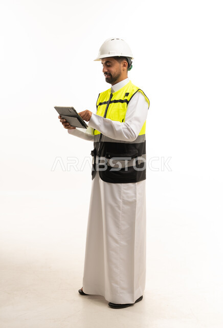 Saudi Engineer in Safety Vest Using Tablet