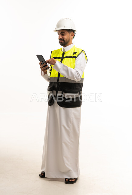 Saudi Engineer in Thobe with Safety Vest and Phone