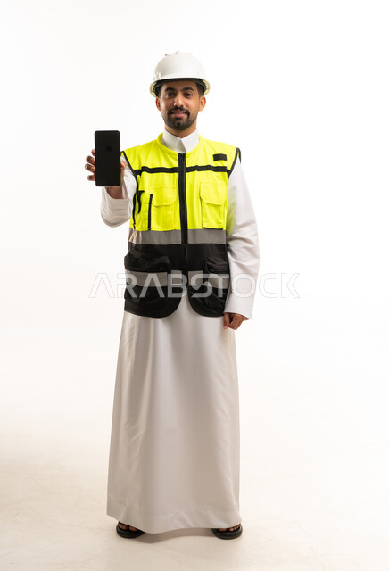 Saudi Engineer in Safety Vest Holding Smartphone