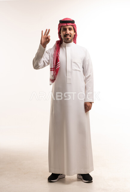 Saudi Man in Traditional Thobe Making OK Gesture