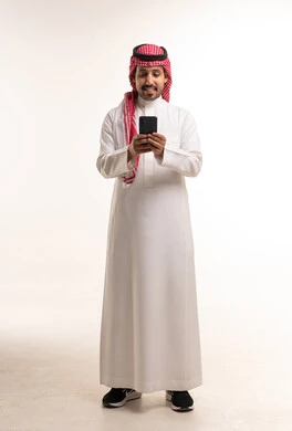 Saudi Man in Traditional Thobe Using Smartphone Studio