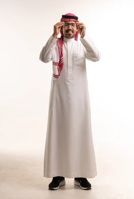 Saudi Man in Traditional Dress Adjusting Glasses