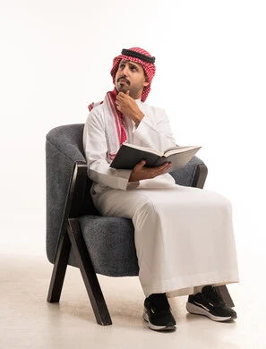 رجل سعودي يقرأ كتاباً في الاستوديو