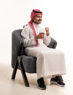Saudi Man Sitting on Armchair with Cold Drink