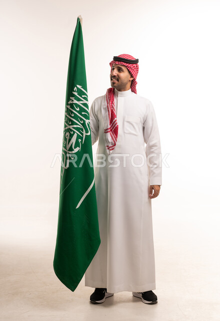 Saudi Man Holding National Flag on White Background