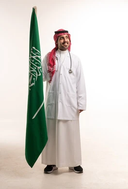 Saudi Doctor Holding Saudi Flag in Medical Uniform