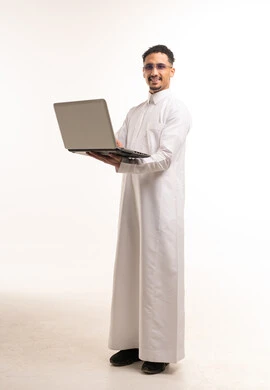 Saudi Man in White Thobe Using Laptop Studio Shot