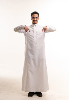 رجل سعودي بالثوب الأبيض يشير للأسفل بخلفية بيضاء