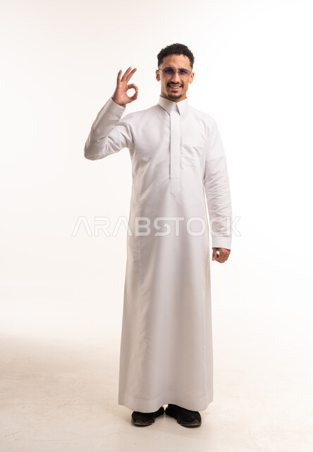 Saudi Man in White Thobe Making OK Hand Gesture