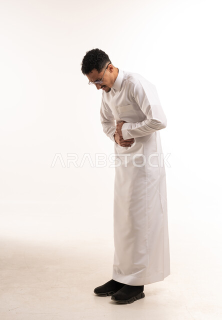 Saudi Man in White Thobe with Stomach Pain