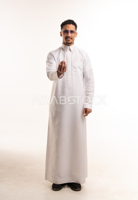 Saudi Man in White Thobe Making Questioning Gesture