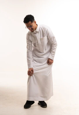 رجل سعودي بالثوب الأبيض يعاني من ألم الساق