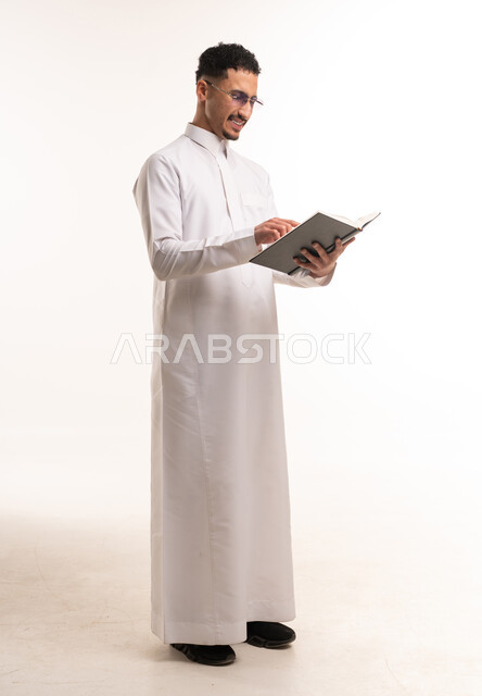 Saudi Man Reading Book in White Thobe