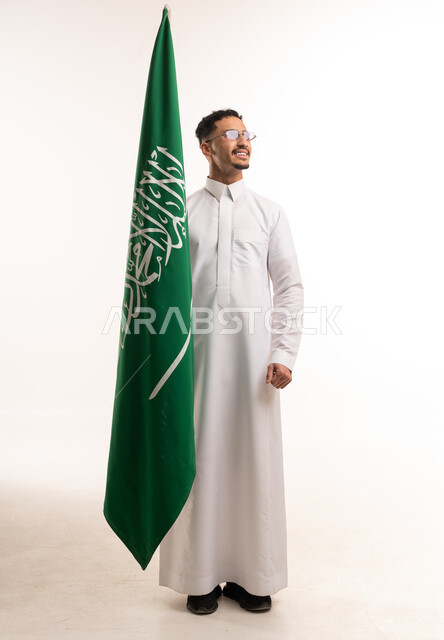 Saudi Man Holding Saudi Arabia Flag in White Thobe