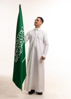 Saudi Man in Thobe Holding National Flag