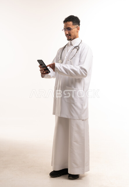 Saudi Male Doctor in Thobe Using Smartphone