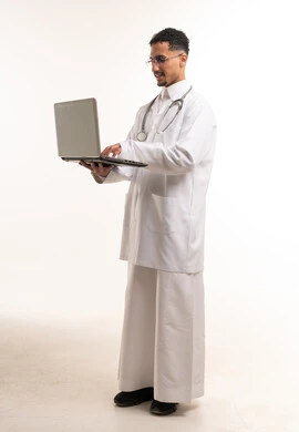 Professional Saudi Male Doctor in White Lab Coat with Laptop