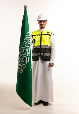 Saudi Engineer Holding National Flag and Safety Gear