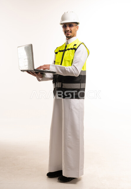 Saudi Engineer with Laptop and Safety Gear in Studio