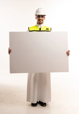 Saudi Engineer in Safety Gear Holding Blank White Sign
