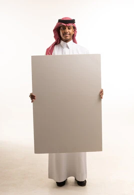Saudi Man Holding Blank White Board in Traditional Dress