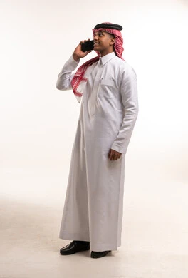 Saudi Man in Traditional Dress Talking on Mobile Phone