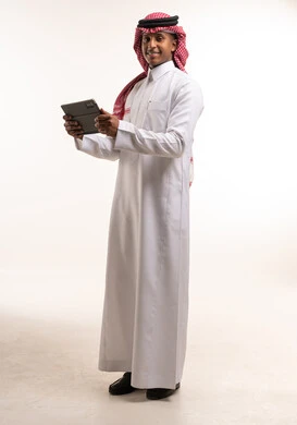 Saudi Man in Thobe Holding Digital Tablet