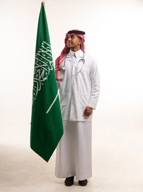 Saudi Doctor with National Flag on White Background