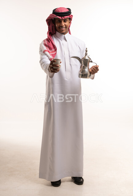 Saudi Man Holding Traditional Arabic Coffee Dallah and Cup
