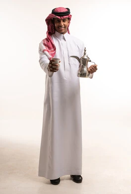 Saudi Man Holding Traditional Arabic Coffee Dallah and Cup