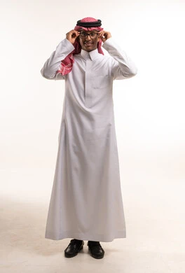 Saudi Man in Traditional Thobe Adjusting Glasses