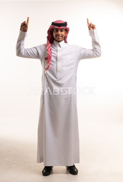 Saudi Man in Traditional Thobe Pointing Upwards Studio
